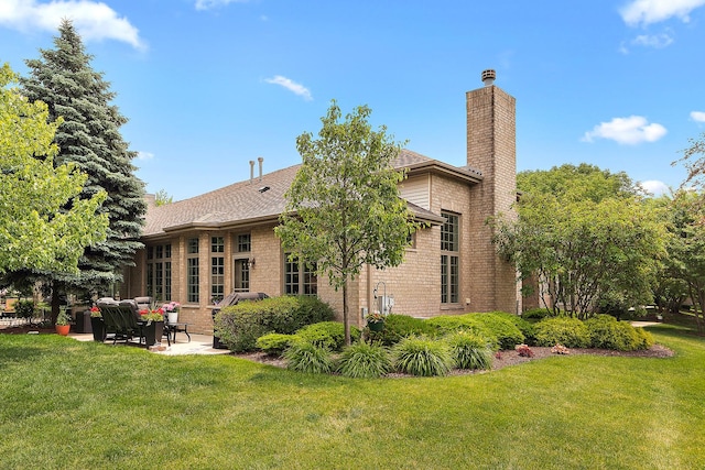 20142 Crystal Lake Way, Frankfort, IL 60423 - back of house with a patio area, an outdoor living space, a lawn, a chimney, and brick siding