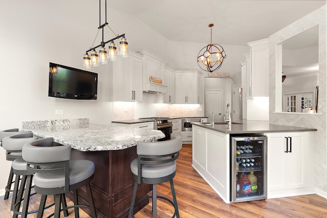 20142 Crystal Lake Way, Frankfort, IL 60423 - bar featuring beverage cooler, light wood finished floors, backsplash, stainless steel appliances, and high vaulted ceiling