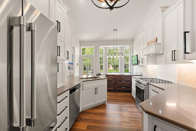 20142 Crystal Lake Way, Frankfort, IL 60423 - kitchen with stainless steel appliances, dark wood-type flooring, a peninsula, decorative light fixtures, and white cabinetry