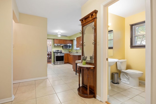 1486 Haverhill Dr, Wheaton, IL 60189 - hallway featuring a sink, light tile patterned flooring, and baseboards