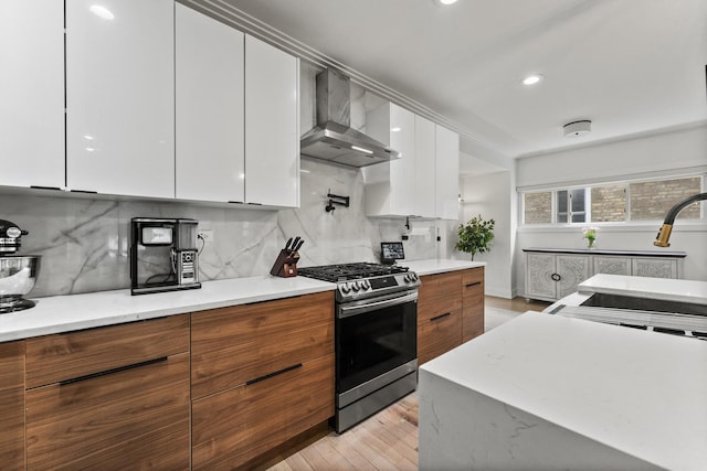 2705 Cuyler Ave, Berwyn, IL 60402 - kitchen with stainless steel gas range oven, wall chimney range hood, modern cabinets, white cabinetry, and recessed lighting