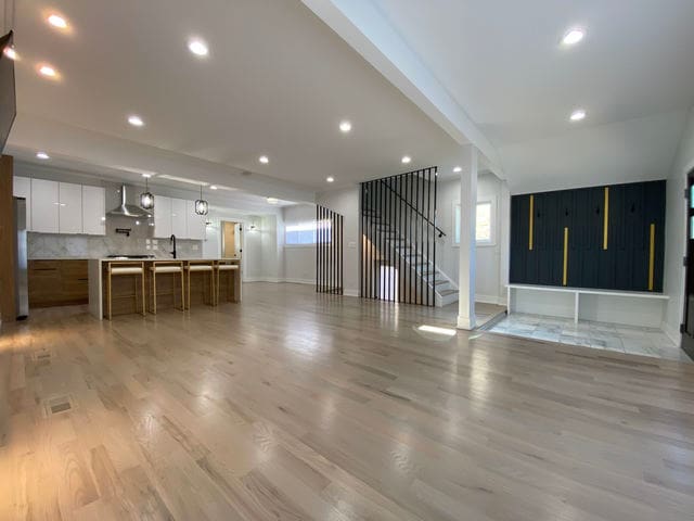 2705 Cuyler Ave, Berwyn, IL 60402 - unfurnished living room with light wood-style floors, recessed lighting, and stairway