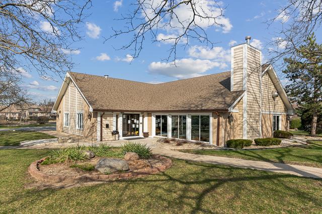 15713 Orlan Brook Dr Unit 97, Orland Park, IL 60462 - rear view of property featuring a lawn and a chimney