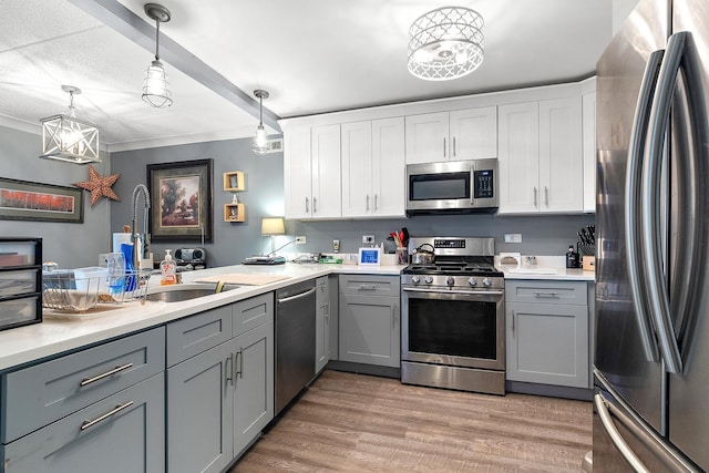 15713 Orlan Brook Dr Unit 97, Orland Park, IL 60462 - kitchen featuring appliances with stainless steel finishes, gray cabinetry, light wood-type flooring, light countertops, and pendant lighting