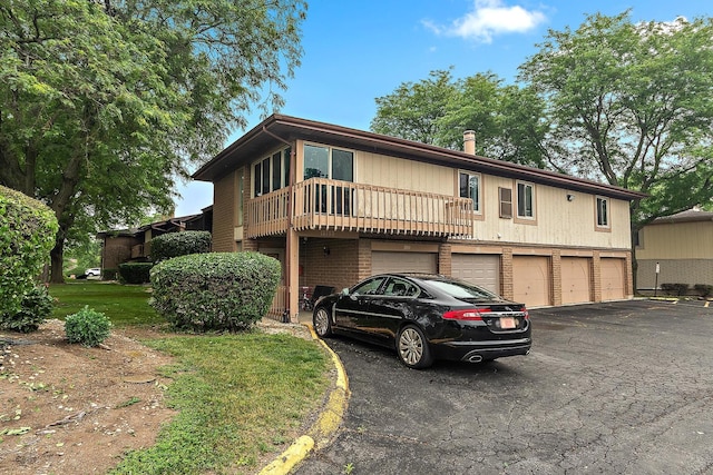 15713 Orlan Brook Dr Unit 97, Orland Park, IL 60462 - view of front facade featuring a garage, driveway, and brick siding