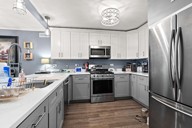 15713 Orlan Brook Dr Unit 97, Orland Park, IL 60462 - kitchen featuring appliances with stainless steel finishes, gray cabinets, dark wood-style flooring, light countertops, and pendant lighting