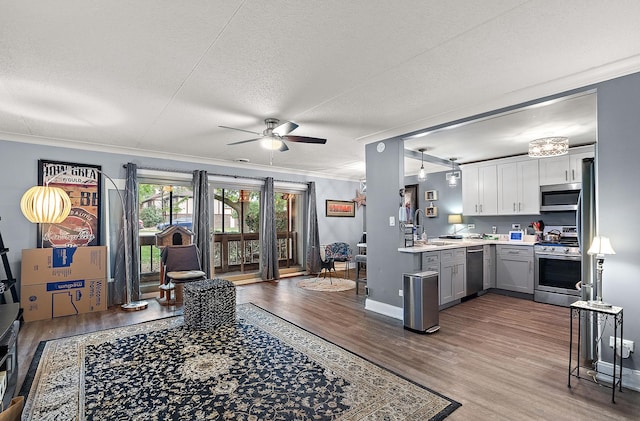 15713 Orlan Brook Dr Unit 97, Orland Park, IL 60462 - living room featuring ceiling fan, wood finished floors, a textured ceiling, and ornamental molding
