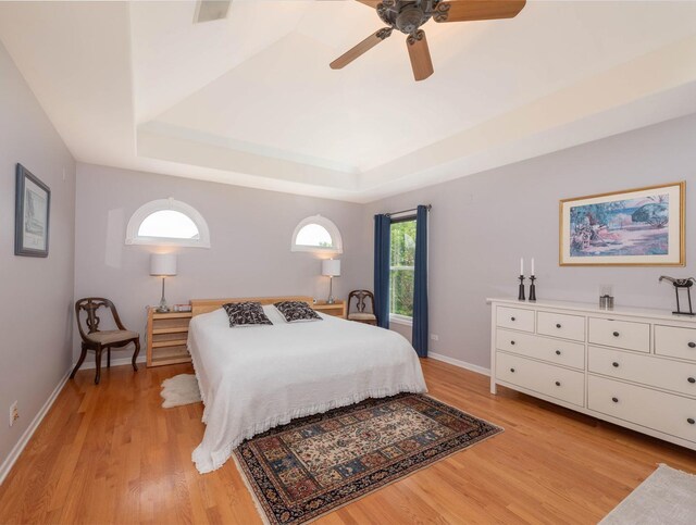 647 Oak Ln, South Elgin, IL 60177 - bedroom with light wood finished floors, a raised ceiling, baseboards, and ceiling fan