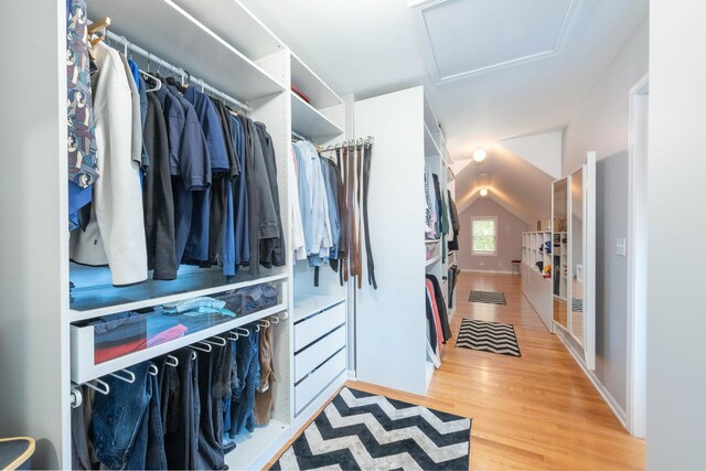 647 Oak Ln, South Elgin, IL 60177 - spacious closet with attic access, light wood-style floors, and vaulted ceiling