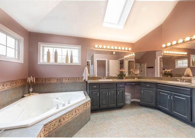 647 Oak Ln, South Elgin, IL 60177 - full bathroom featuring vaulted ceiling, a skylight, double vanity, and a tub with jets