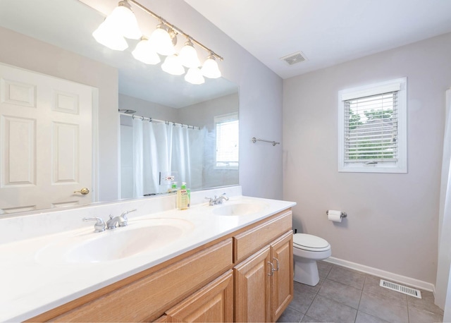 647 Oak Ln, South Elgin, IL 60177 - bathroom featuring plenty of natural light, double vanity, toilet, and tile patterned flooring