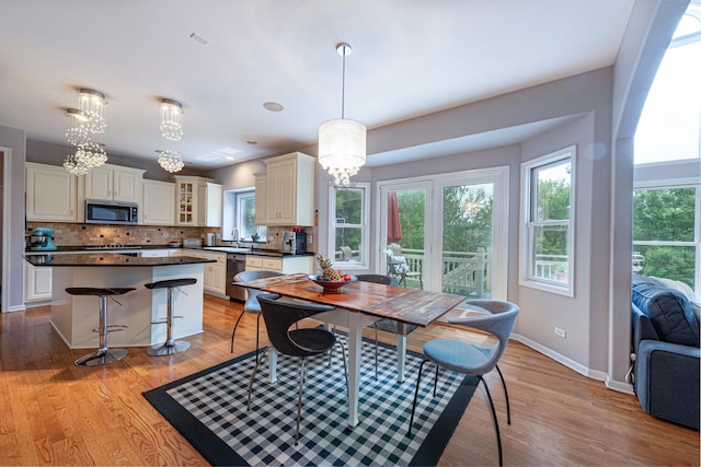 647 Oak Ln, South Elgin, IL 60177 - dining space featuring a chandelier, healthy amount of natural light, and light wood-style flooring