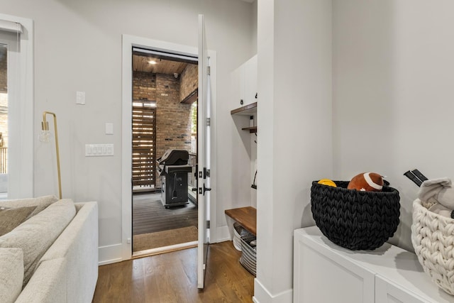 1304 N Hoyne Ave Unit 1, Chicago, IL 60622 - mudroom with wood finished floors, baseboards, and brick wall