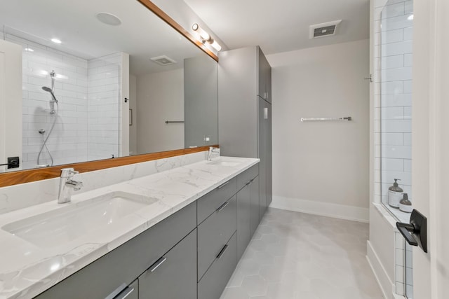 1304 N Hoyne Ave Unit 1, Chicago, IL 60622 - bathroom featuring double vanity, tile patterned flooring, baseboards, and tiled shower