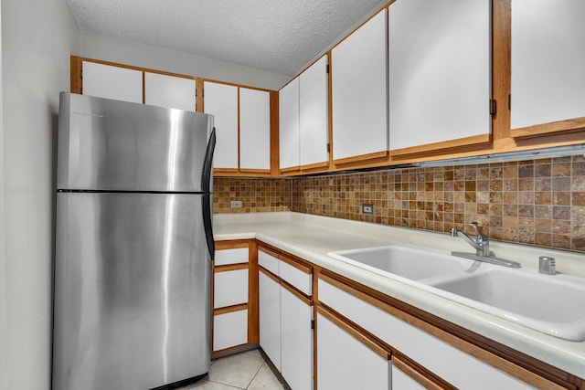 1122 N Clark St Unit 1710, Chicago, IL 60610 - kitchen with freestanding refrigerator, a sink, light countertops, tasteful backsplash, and a textured ceiling