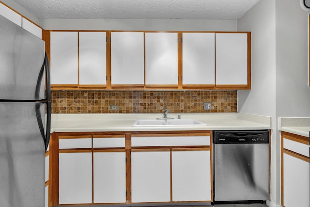 1122 N Clark St Unit 1710, Chicago, IL 60610 - kitchen with appliances with stainless steel finishes, a sink, light countertops, tasteful backsplash, and a textured ceiling
