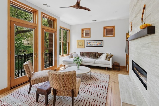 920 W Wolfram St Unit 3, Chicago, IL 60657 - living area featuring a large fireplace, ceiling fan, light wood-style floors, and baseboards