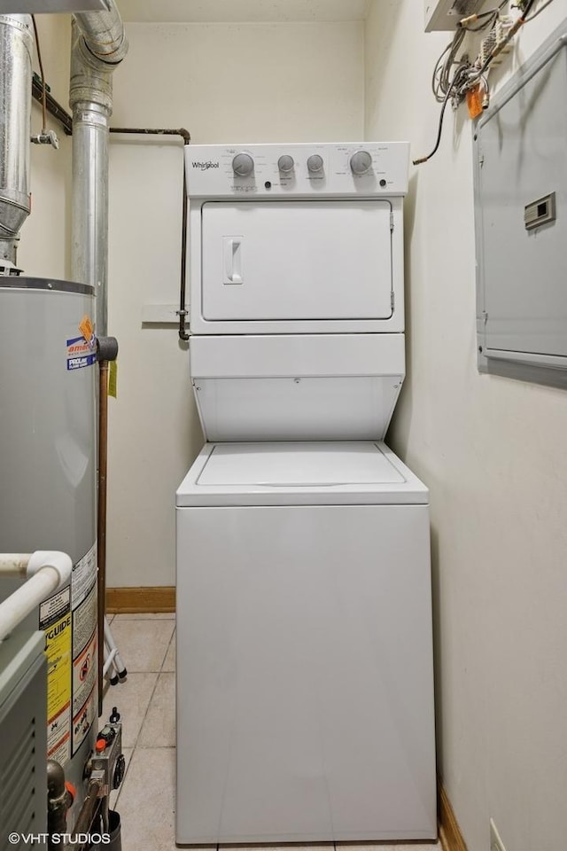 920 W Wolfram St Unit 3, Chicago, IL 60657 - washroom featuring estacked washer and dryer, gas water heater, light tile patterned floors, and baseboards
