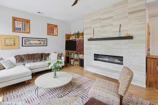 920 W Wolfram St Unit 3, Chicago, IL 60657 - living room with wood finished floors, a ceiling fan, and a tile fireplace
