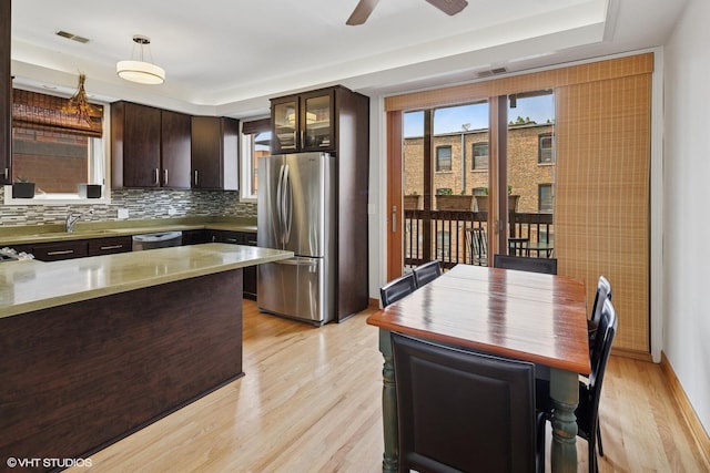 920 W Wolfram St Unit 3, Chicago, IL 60657 - kitchen featuring stainless steel appliances, light wood-style flooring, dark brown cabinetry, ceiling fan, and decorative light fixtures