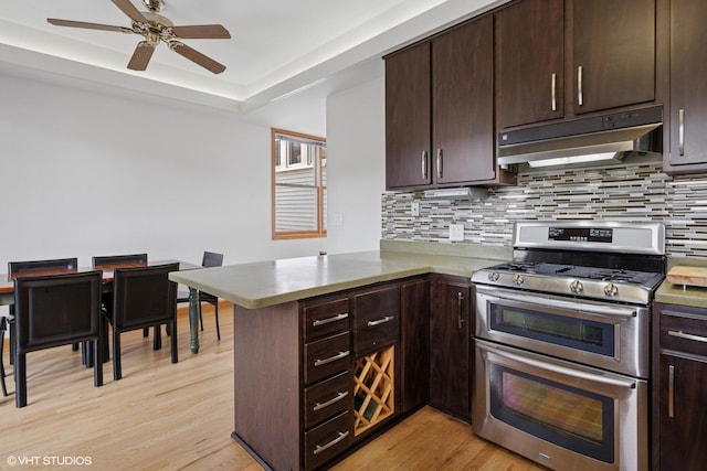 920 W Wolfram St Unit 3, Chicago, IL 60657 - kitchen with double oven range, under cabinet range hood, a peninsula, and decorative backsplash