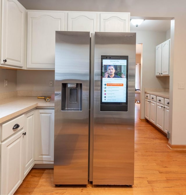 0S630 Hubbard Pl, Geneva, IL 60134 - kitchen featuring stainless steel fridge with ice dispenser, light wood-style flooring, white cabinets, and light countertops