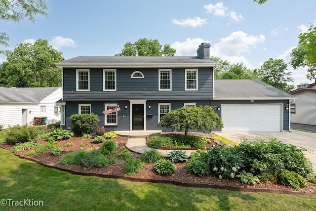 2609 Dougall Rd, Joliet, IL 60433 - colonial house featuring a chimney, an attached garage, and concrete driveway