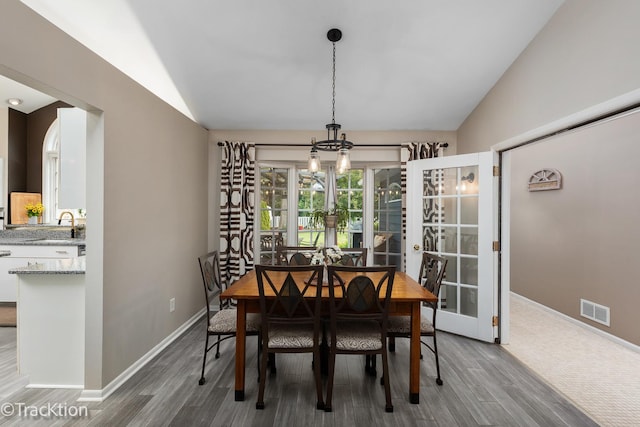 2609 Dougall Rd, Joliet, IL 60433 - dining room with lofted ceiling, wood finished floors, a chandelier, and baseboards