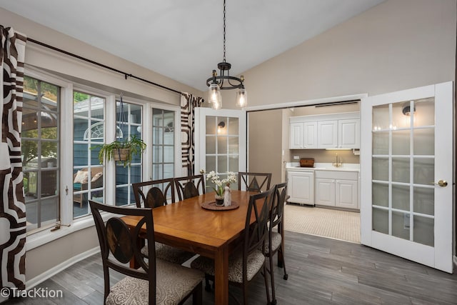 2609 Dougall Rd, Joliet, IL 60433 - dining area featuring vaulted ceiling, dark wood-style floors, and a chandelier