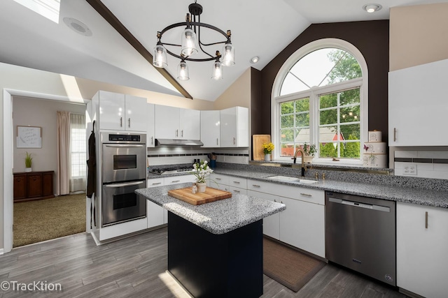 2609 Dougall Rd, Joliet, IL 60433 - kitchen featuring stainless steel appliances, a sink, a chandelier, white cabinetry, and high vaulted ceiling