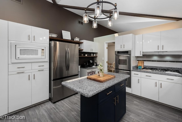 2609 Dougall Rd, Joliet, IL 60433 - kitchen featuring appliances with stainless steel finishes, backsplash, open shelves, under cabinet range hood, and a center island