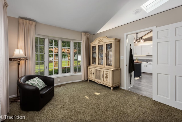 2609 Dougall Rd, Joliet, IL 60433 - living area featuring vaulted ceiling, a skylight, carpet, baseboards, and a chandelier