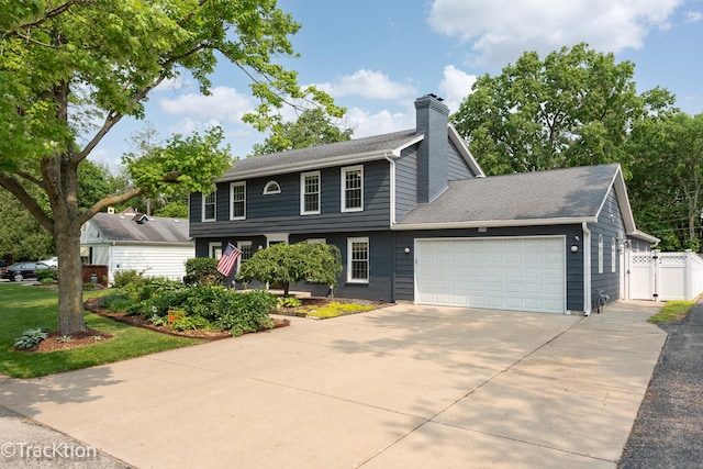 2609 Dougall Rd, Joliet, IL 60433 - colonial-style house with a garage, a chimney, driveway, a gate, and roof with shingles