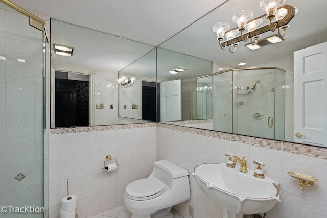 2609 Dougall Rd, Joliet, IL 60433 - full bathroom featuring a chandelier, tile walls, a sink, a shower stall, and toilet