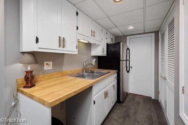 2609 Dougall Rd, Joliet, IL 60433 - kitchen with freestanding refrigerator, white cabinets, light countertops, dark colored carpet, and a drop ceiling