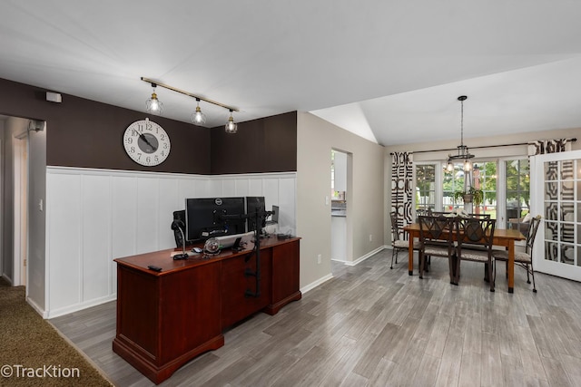2609 Dougall Rd, Joliet, IL 60433 - living area featuring wood finished floors, a desk, lofted ceiling, rail lighting, and a decorative wall