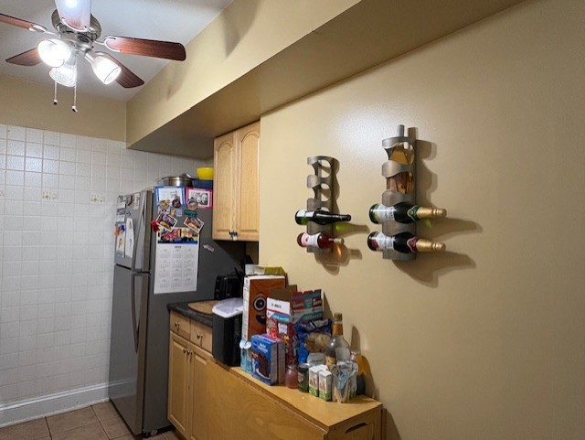 10811 S Keating Ave Unit 3Se, Oak Lawn, IL 60453 - kitchen featuring ceiling fan, light tile patterned floors, freestanding refrigerator, and dark countertops