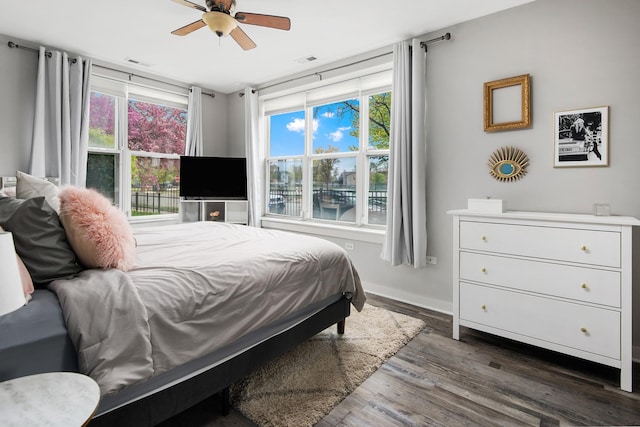 2257 W Lake St Unit 101, Chicago, IL 60612 - bedroom featuring multiple windows, dark wood-style flooring, and baseboards