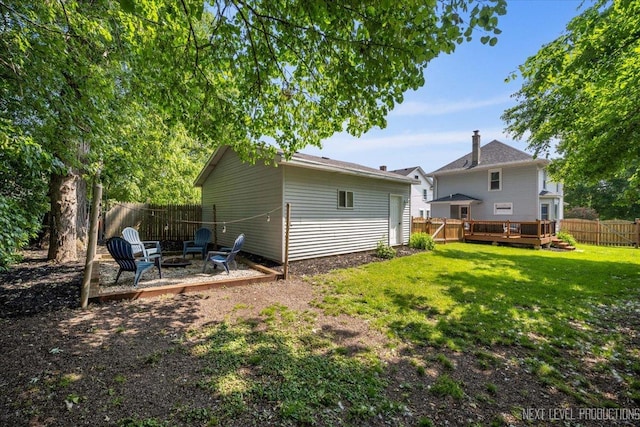 721 S Batavia Ave, Batavia, IL 60510 - rear view of house featuring an outdoor fire pit, a fenced backyard, a deck, and an outdoor structure