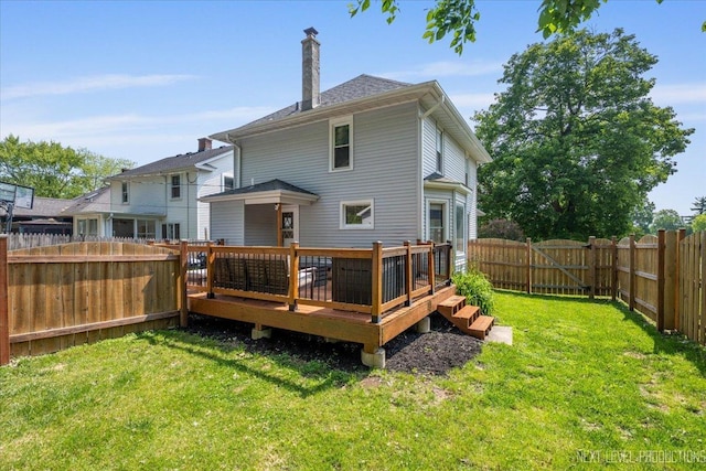 721 S Batavia Ave, Batavia, IL 60510 - rear view of house with a fenced backyard, a deck, a chimney, and a gate