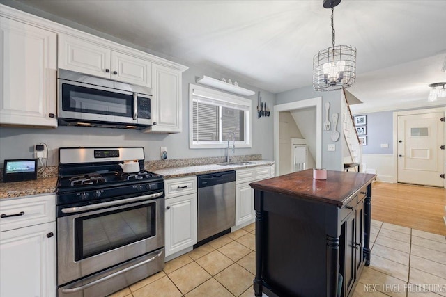 721 S Batavia Ave, Batavia, IL 60510 - kitchen with appliances with stainless steel finishes, light tile patterned floors, a chandelier, white cabinetry, and wood counters