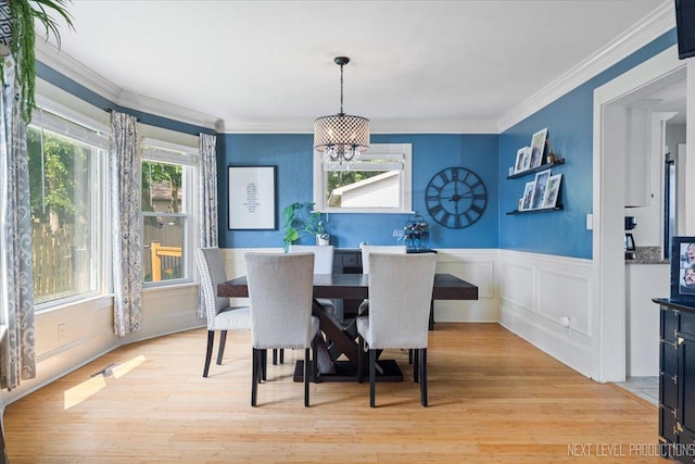 721 S Batavia Ave, Batavia, IL 60510 - dining area featuring a chandelier, a wainscoted wall, ornamental molding, light wood-type flooring, and a decorative wall