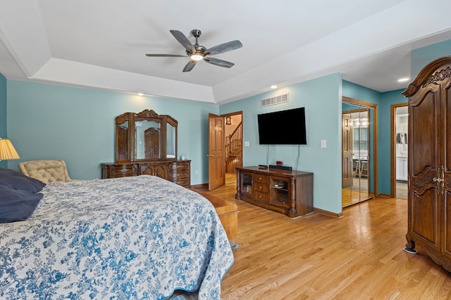 6897 Galena Rd, Bristol, IL 60512 - bedroom featuring a tray ceiling, light wood-type flooring, baseboards, and a ceiling fan