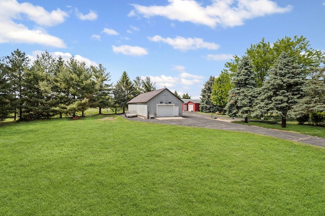 6897 Galena Rd, Bristol, IL 60512 - view of grassy yard featuring an outbuilding, a detached garage, and driveway