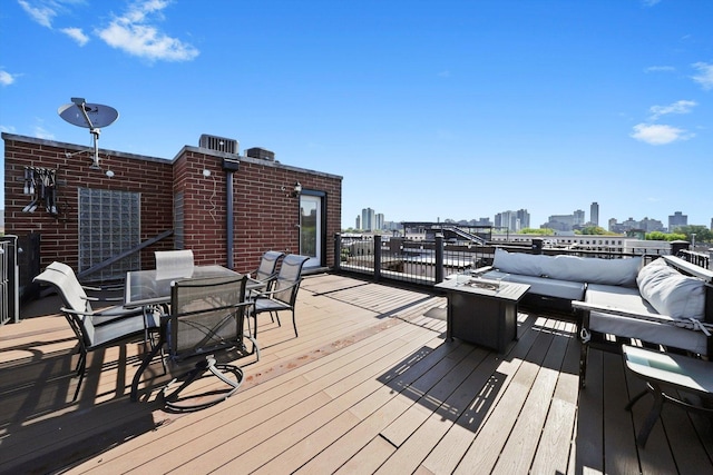 851 W Fletcher St Unit 2, Chicago, IL 60657 - wooden deck with a view of skyline, outdoor dining space, and an outdoor living space with a fire pit