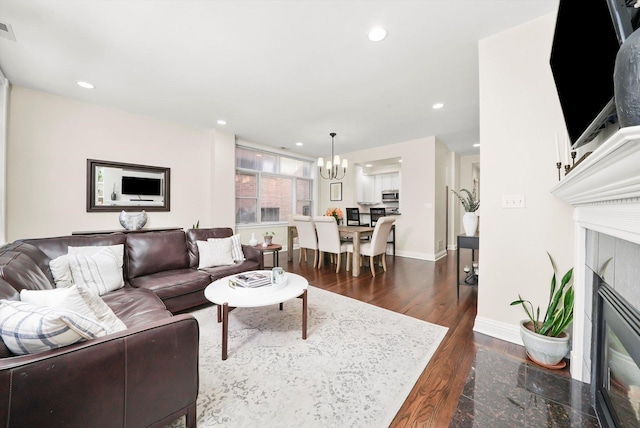 851 W Fletcher St Unit 2, Chicago, IL 60657 - living room featuring a chandelier, dark wood finished floors, a tiled fireplace, baseboards, and recessed lighting