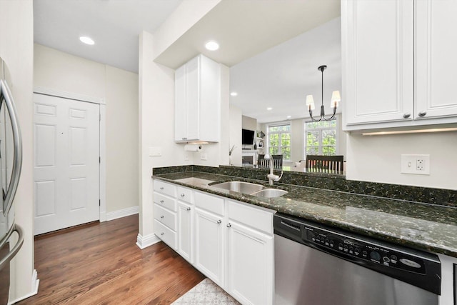 851 W Fletcher St Unit 2, Chicago, IL 60657 - kitchen featuring appliances with stainless steel finishes, white cabinets, dark wood-type flooring, a sink, and dark stone countertops