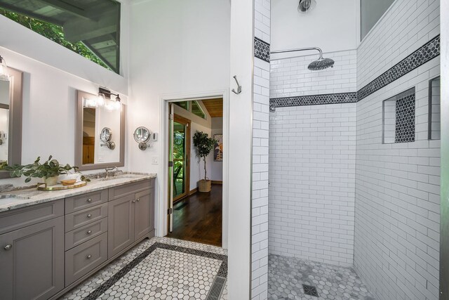 4N650 Pheasant Run Dr, Saint Charles, IL 60175 - bathroom with double vanity, a tile shower, and lofted ceiling
