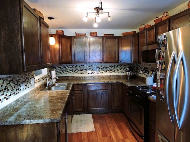 19510 116th Ave Unit D, Mokena, IL 60448 - kitchen with appliances with stainless steel finishes, a sink, dark countertops, and dark wood-type flooring