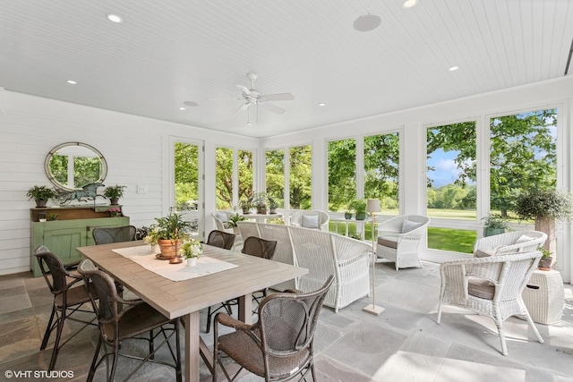 sunroom / solarium featuring stone finish flooring and recessed lighting